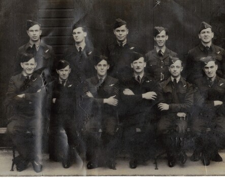 Black and white photograph of 11 airmen 4 standing