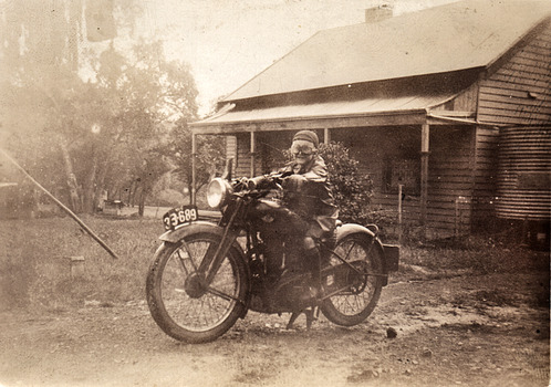 Billy on motorbike outside grandmas place. 