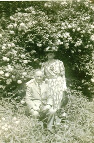 Black and white photograph of Emil & Mary Jack (Jackschowsky) in a garden. Emil is seated. Mary is the daughter of August Schwerkolt and his second wife Wilhelmena.