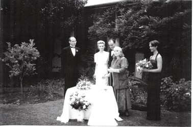 Black & white photocopy of the marriage of Caroline Schwerkolt and Julian Browne outside the Schwerkolt Cottage. Table with a white cloth in front