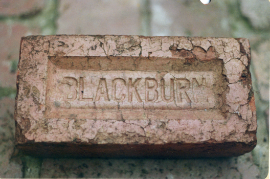 Red brick stamped 'Blackburn'. One of the major industries in Blackburn.