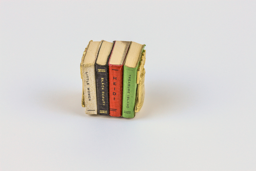 Miniature books in bookcase.