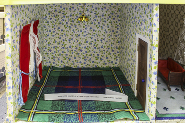 Back bedroom, first floor papered with violet flowered wallpaper and floor covering: tartan carpet