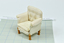 White padded armchair with buttoned, silk upholstery and white seat cushion, four wooden legs