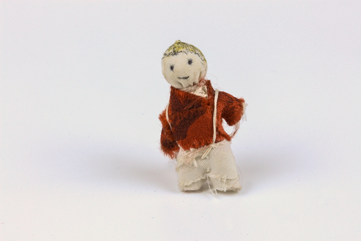 Cloth doll dressed in cotton trousers and red velvet shirt