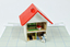 Miniature toy doll's house containing a miniature doll's house and cloth doll