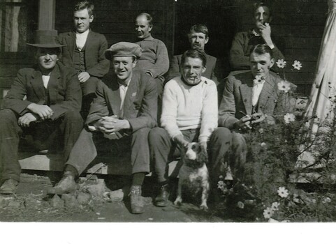 Black and white photograph of eight men in a group.