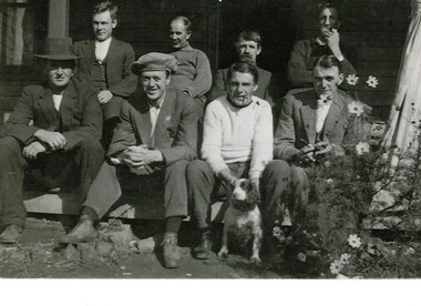 Black and white photograph of eight men in a group.