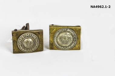 Rectangular, brass-coloured belt buckles.