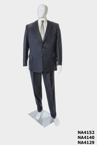 Charcoal grey 1958 man's suit with medium width lapels with button hole on left lapel.