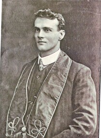 Louis James Barelli wearing formal suit and sash.