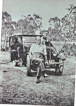 Louis Barelli sitting on the bumper bar of a 1927 Morris Cowley.