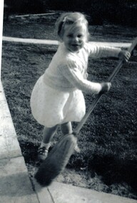 Julie Suto with a broom.