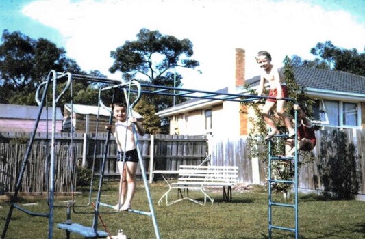 Trevor and Michael Gardiner playing on swing set