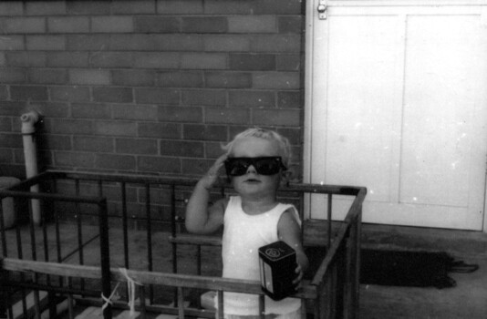 Nick in play pen in backyard