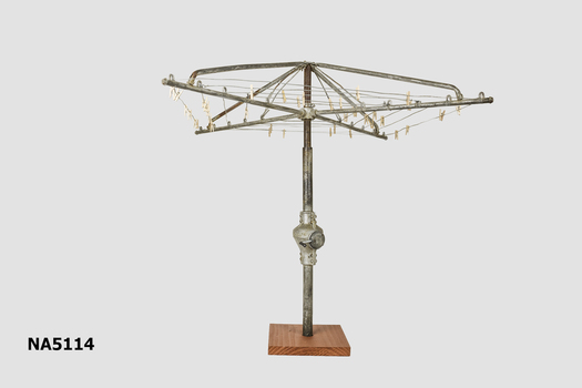 Miniature rotary clothesline with wooden base.