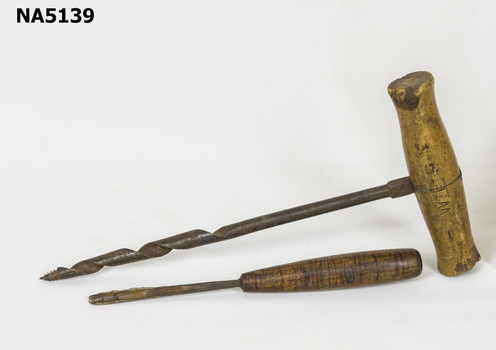 Steel hand chisel and gimlet each with wooden handle.