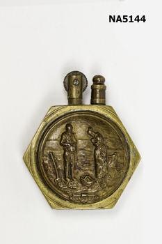A brass/bronze hexagon cigarette lighter 