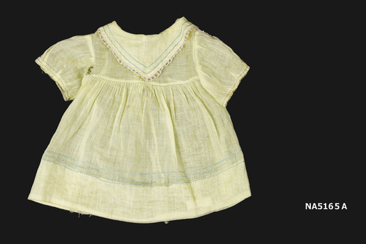 Lemon coloured doll's dress which matches the bonnet.