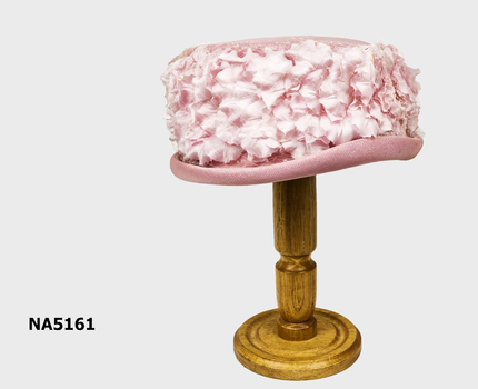 Pink hat on the stand.