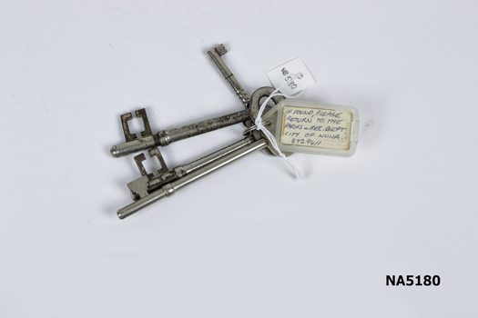 Four keys on tag with plastic label.