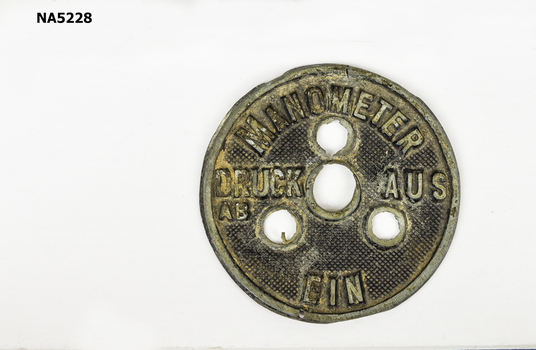 Round metal badge.