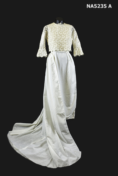 White cotton long wedding dress with train and lace over blouse.