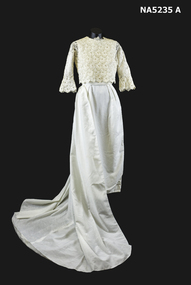 White cotton long wedding dress with train and lace over blouse.