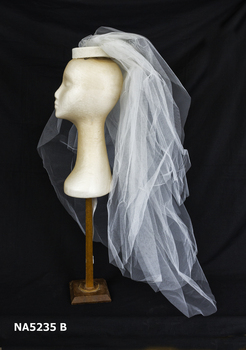 Short veil complementing the wedding dress.
