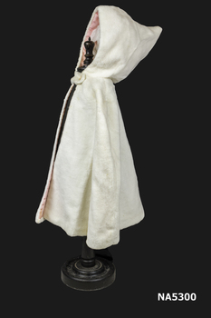 Child's cream synthetic fur bolero with hood and lining.