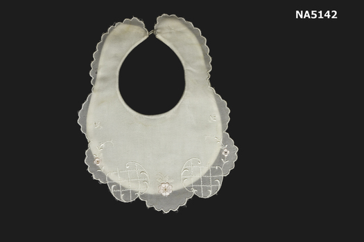 White cotton bib with nylon overlay.