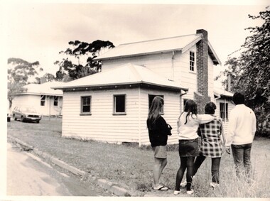 Four girls standing in the grounds of Winlaton outside a building.
