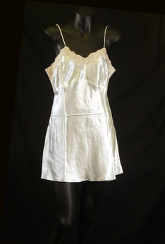 Camisole has coffee coloured lace along the top edge and rouleau style shoestring straps.