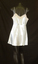 Camisole has coffee coloured lace along the top edge and rouleau style shoestring straps.