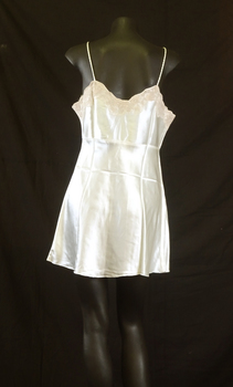 Camisole has coffee coloured lace along the top edge and rouleau style shoestring straps.