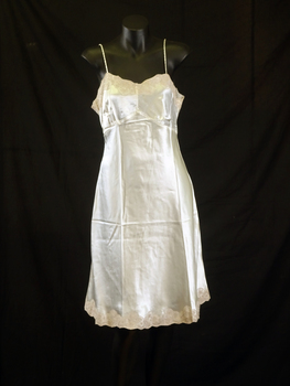 Petticoat has coffee coloured lace around the hem and yoke. It has rouleau style shoestring straps.
