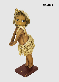 Doll on wooden stand