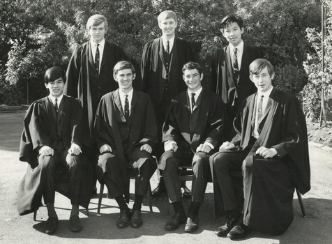 Black and white photograph showing five male residents of International House dressed in suits and academic gowns.