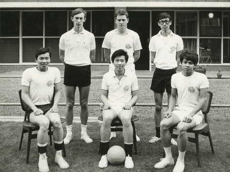 Black and white photograph showing six male residents of International House, members of the volleyball team, dressed in shorts and white t-shirts.