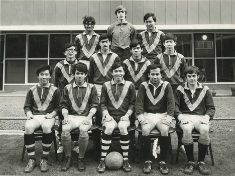 Black and white photograph showing twelve male residents of International House dressed in their soccer kit.