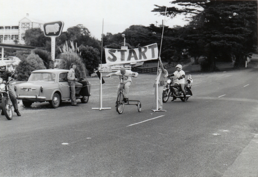 Black and white photograph of start sign and trike racers in Portsea, Victoria