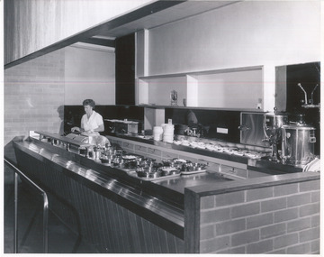 Woman working in the servery at International House