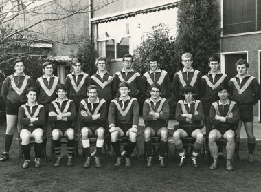Sixteen male members of the International House football team in a formal team photograph.