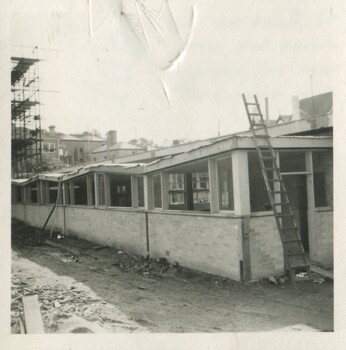 A latter leaned against a partially built building