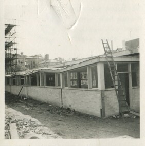 A latter leaned against a partially built building