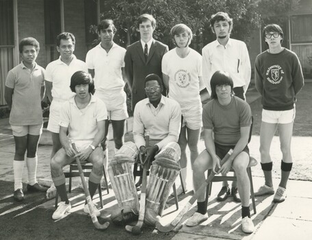 Ten young male students in collared white, one suit, and some casual sports wear 