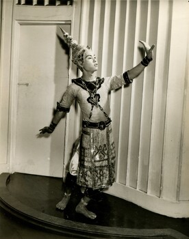 Young boy in traditional Thai sarong holding a dance pose