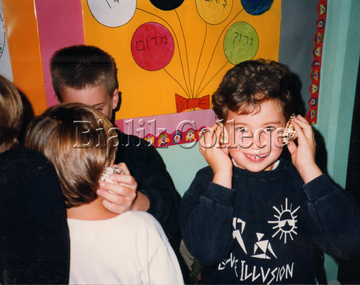 Photograph, ELC students playing with shells, c. 2000s