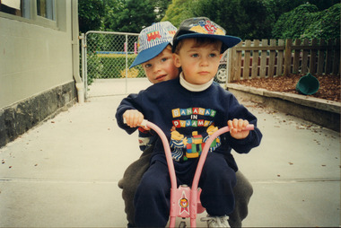 Photograph (Item) - ELC students riding a tricycle, c. 1990s, c. 1990s