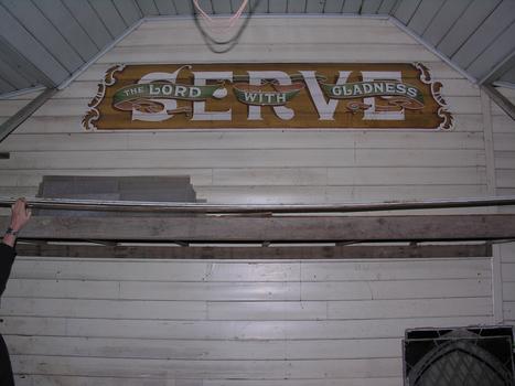 Sign inside a weatherboard church